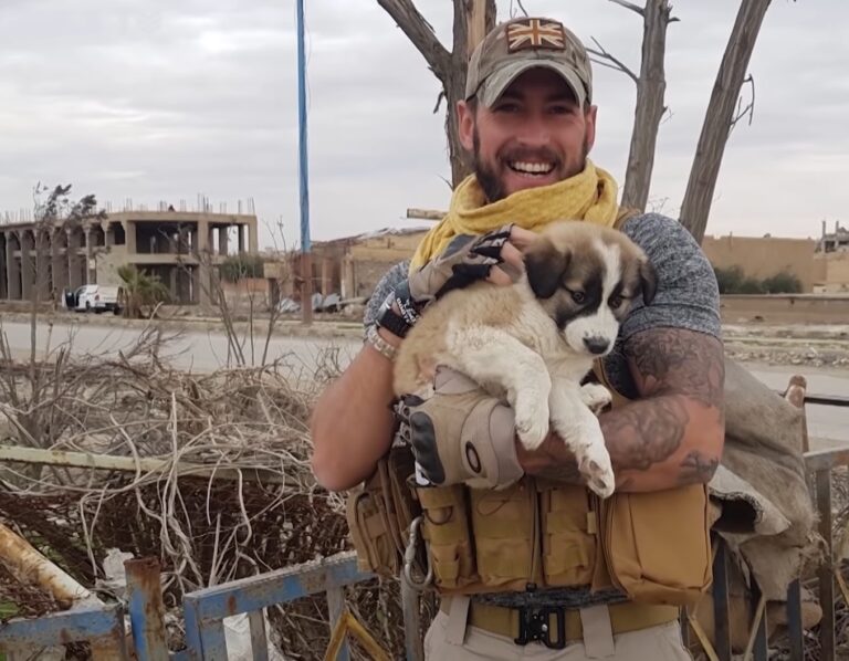 After rescuing a puppy from the debris, the soldier carries his loyal companion in his backpack, ensuring their constant presence and protection. - Puppies Love