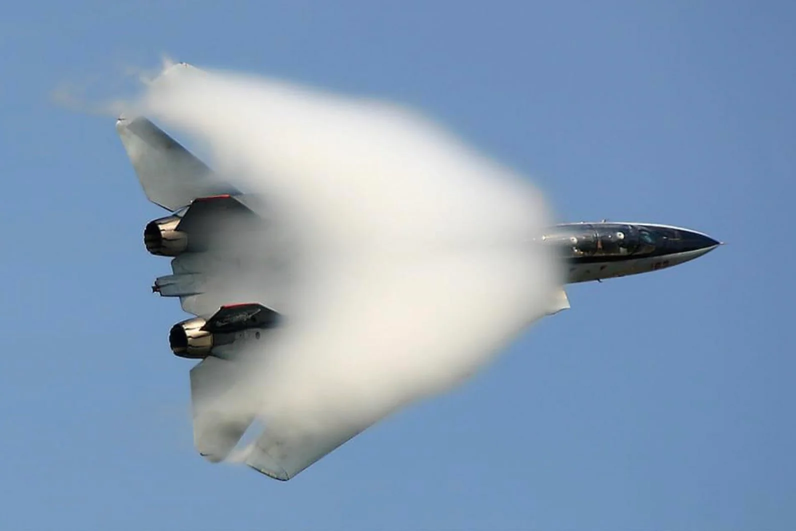 The F14 Tomcat reaches the speed of sound, producing a stunning vapor cone.