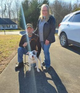 The shelter dog meets his new family and joyfully runs towards them, giving hugs affectionately. - Puppies Love