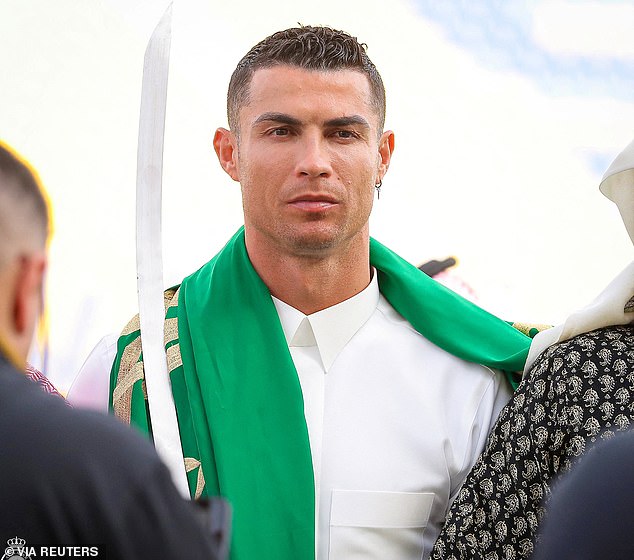 Cristiano Ronaldo donned 'special' traditional Middle Eastern garb in honor of Saudi Arabia's Founding Day... and was seen wearing a golden robe, dancing with a Sword and smiling with the national flag on shoulder