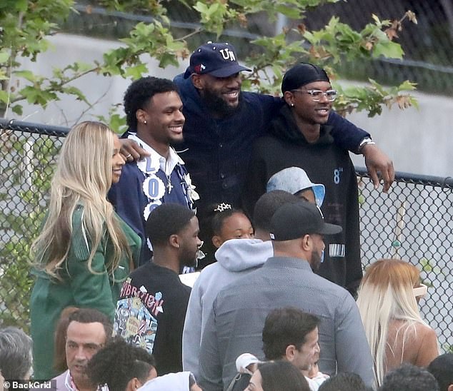 LeBron James plays the role of doting dad as he and wife Savannah watch son Bronny graduate from high school - Sports News