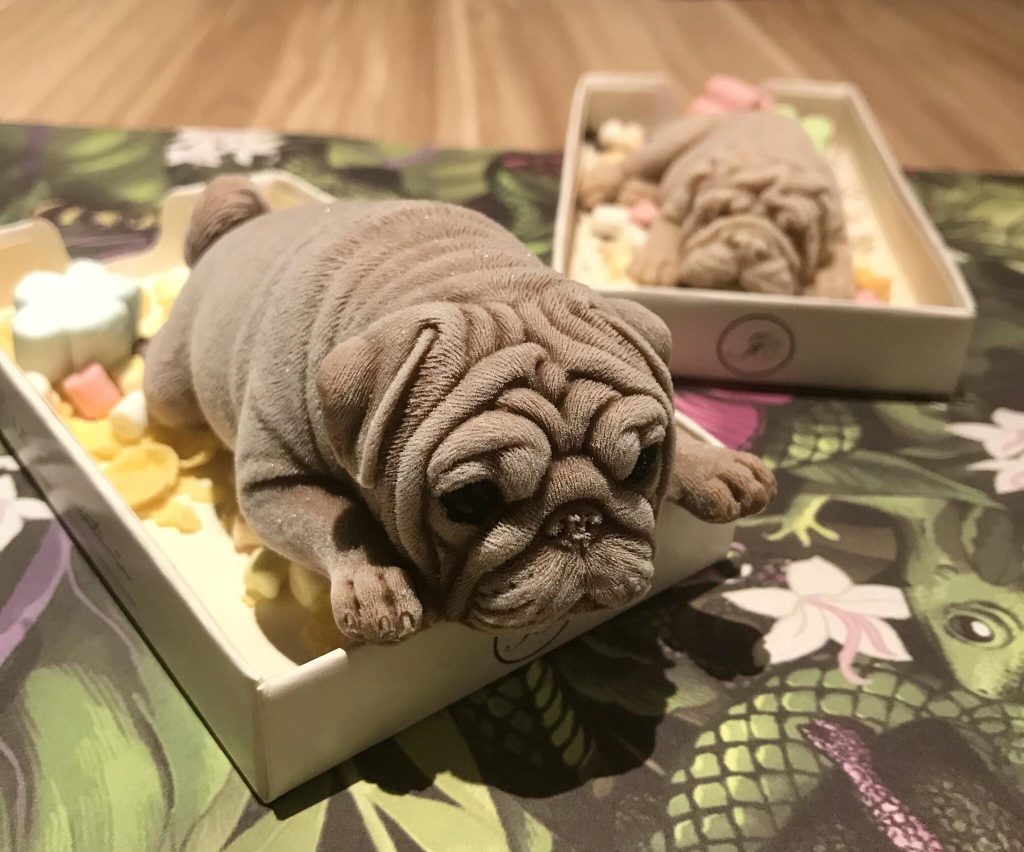 A viral video captures the astonishing reaction of a big dog in sheer disbelief as its owner cuts a pug-shaped ice cream with a spoon, leaving the dog in a state of shock and awe. – Puppies Love