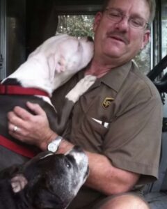 A UPS driver has a heartwarming connection with all the dogs on his delivery route