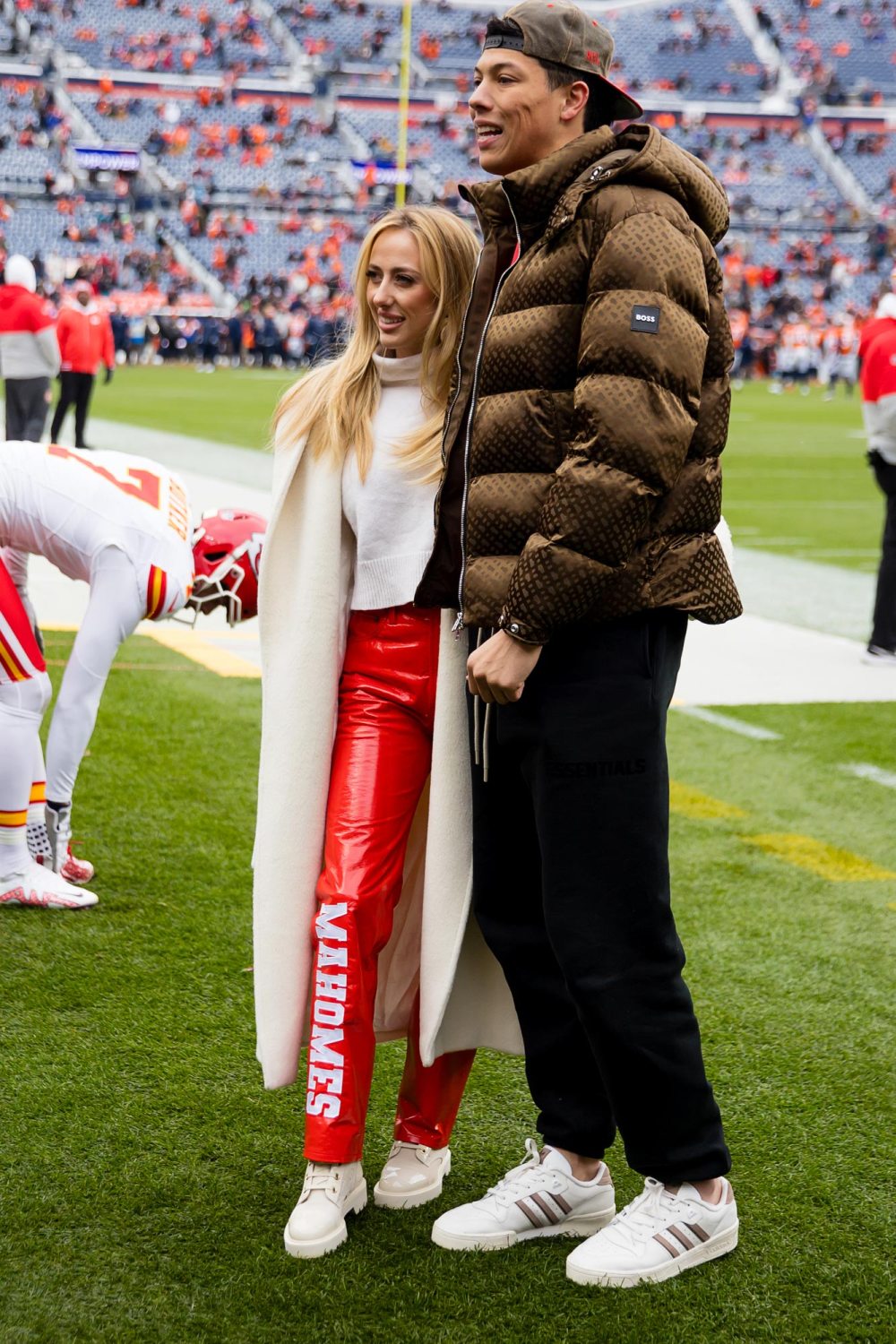 Chic Winter Game Ensemble: Brittany Mahomes Stuns in Cream Coat and Red Leather Pants at Chiefs Match - amazingdailynews.com