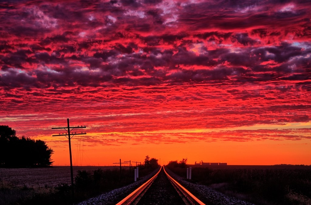 Witness the annual miracle as the sun’s mesmerizing reflection dances upon the railroad tracks, inviting you to capture a photograph that encapsulates the enchantment of this fleeting moment in time.vouyen