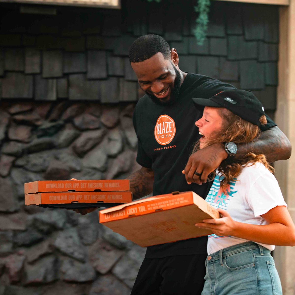 In order to act like a delivery guy, LeBron James hands out pizza on the street. 'No, my name is Ron, I have no idea who LeBron is.'
