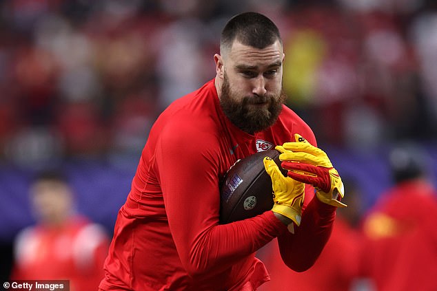 On the field, Travis was warming up for the game - which begins at 6:30pm EST (3:30pm local)