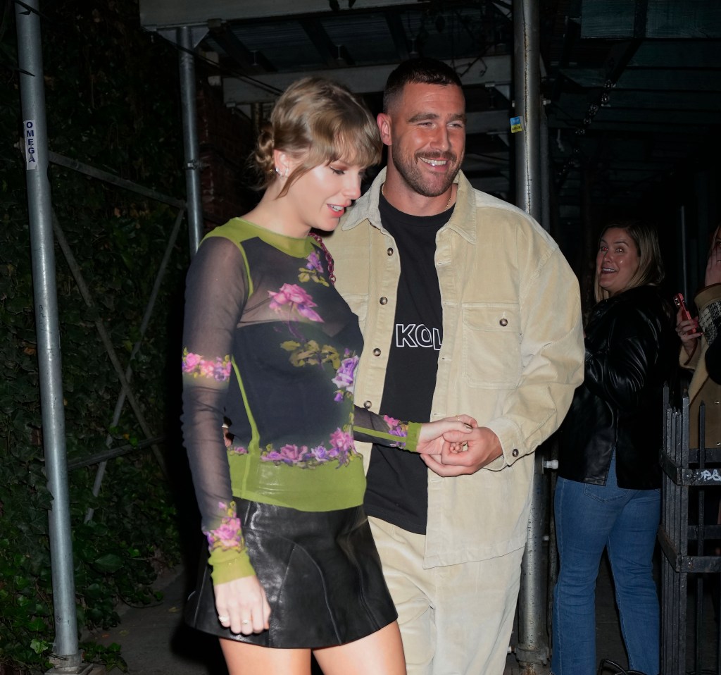 Taylor Swift and Travis Kelce holding hands in New York City.