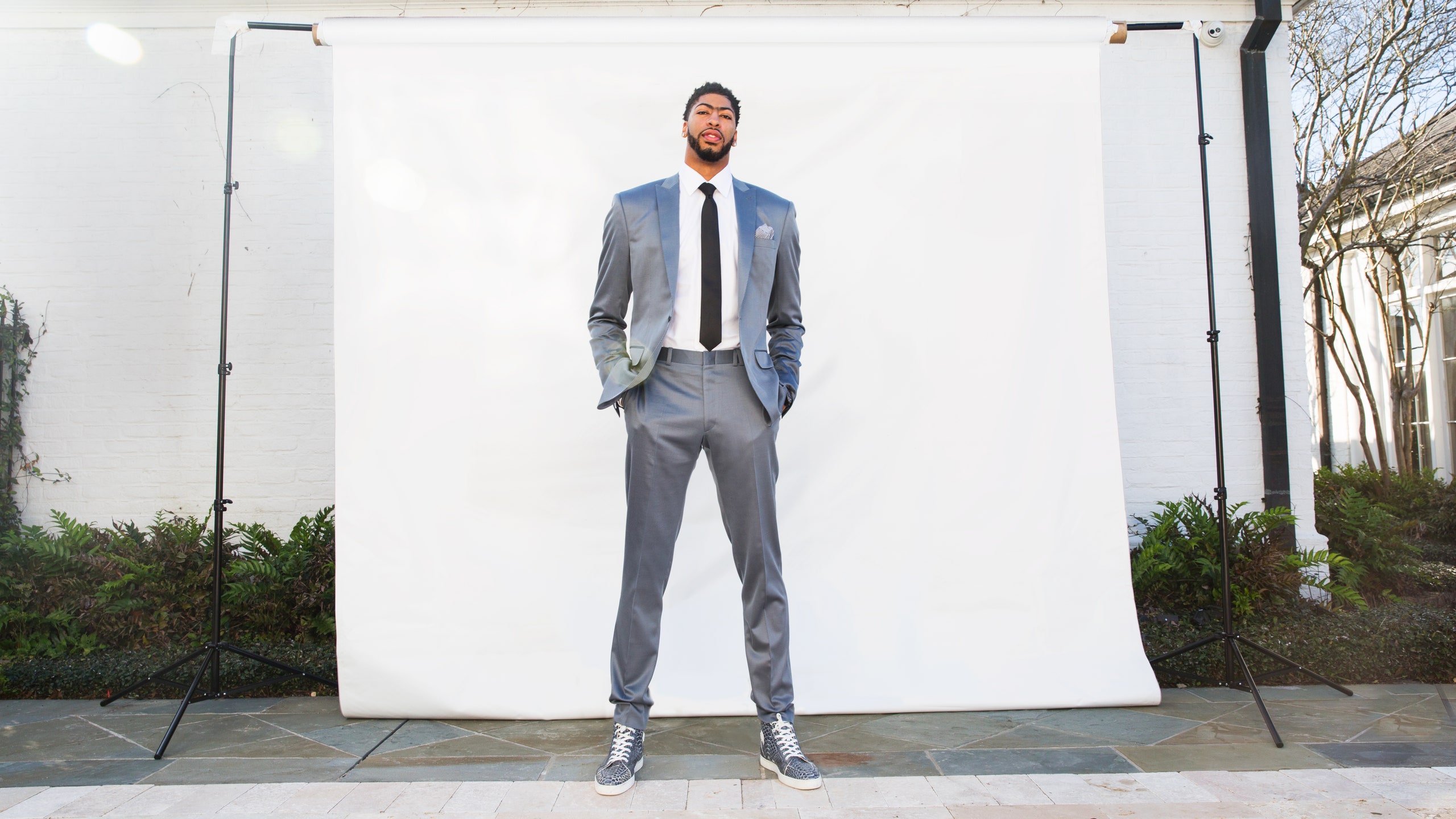 This image may contain Anthony Davis Clothing Apparel Coat Overcoat Suit Footwear Shoe Human Person Man and Blazer