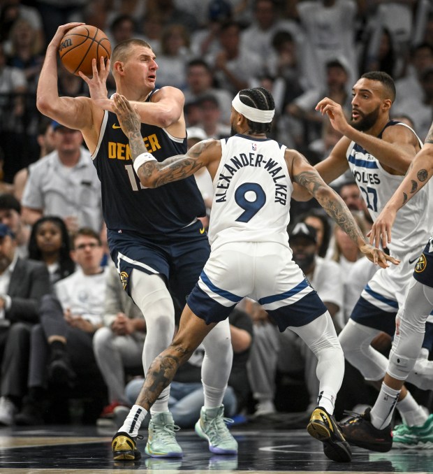 Nikola Jokic (15) of the Denver Nuggets takes contact from...