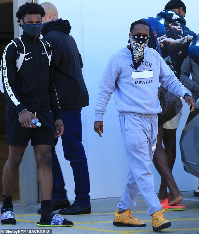 Squad goals: He carried a pair from his new Nikes (which will retail for $200 later this year), as he left the gym with Bronny, 16, and his sports agent Rich Paul, 38